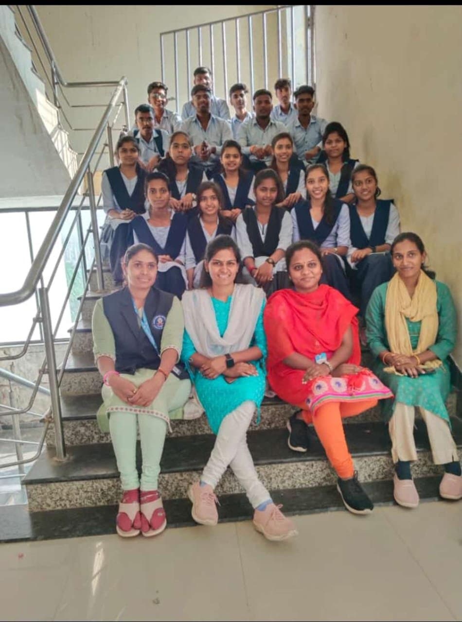 Students and faculty group photo on the college staircase